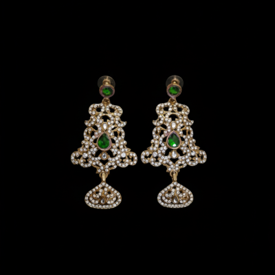 Traditional Indian style statement earrings with green pear-cut gemstones and white stone embellishments in a vintage filigree design.