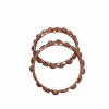 Top-down view of two rose gold bangles featuring a textured, beaded outer rim and cut-out detailing on the inner frame.