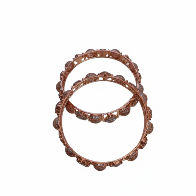 Top-down view of two rose gold bangles featuring a textured, beaded outer rim and cut-out detailing on the inner frame.