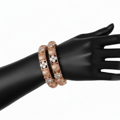Two rose gold bangles displayed on a black mannequin hand. The design features alternating circular textured rose gold medallions and square settings containing four-petal floral clusters of white stones.