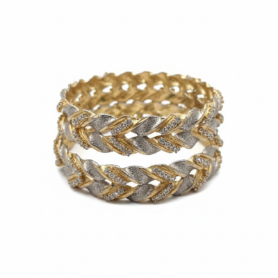 Elegant pair of two-tone gold and silver braided bangles studded with small diamonds.