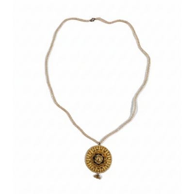 Full view of a vintage-style gold medallion necklace with a long translucent beaded chain and a dangling crystal charm at the bottom.