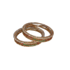 Two traditional gold-toned bangles resting horizontally and slightly overlapping on a white surface. The image emphasizes the thin, elegant profile of the bangles and the sparkle of the embedded red, green, and white stones.