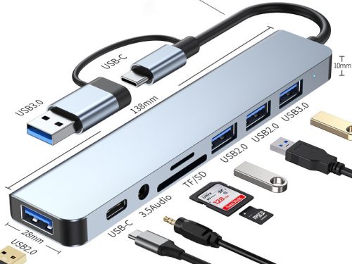 A sleek grey 7-in-1 USB-C docking station featuring a dual USB-C and USB-A connector cable, displayed on a wooden surface next to a stacked laptop, tablet, and smartphone.